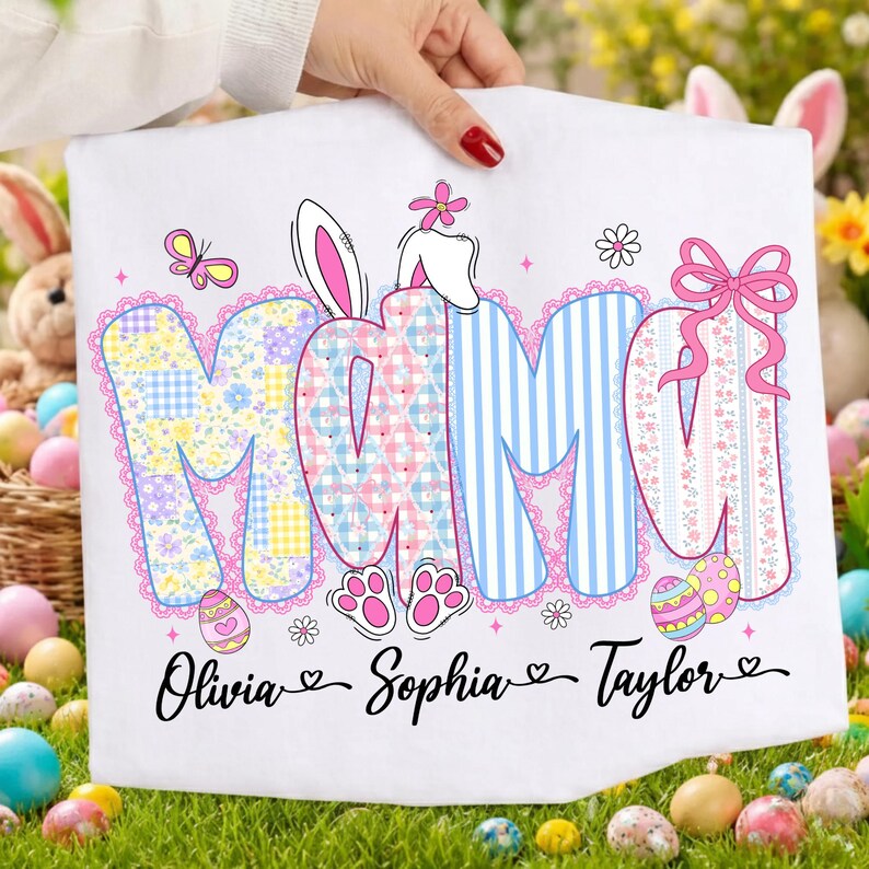 May include: White Easter-themed decorative towel with the word "MAMA" in pastel colors. The letters are decorated with floral patterns, stripes, and a pink bow. Includes the names Olivia, Sophia, and Taylor.