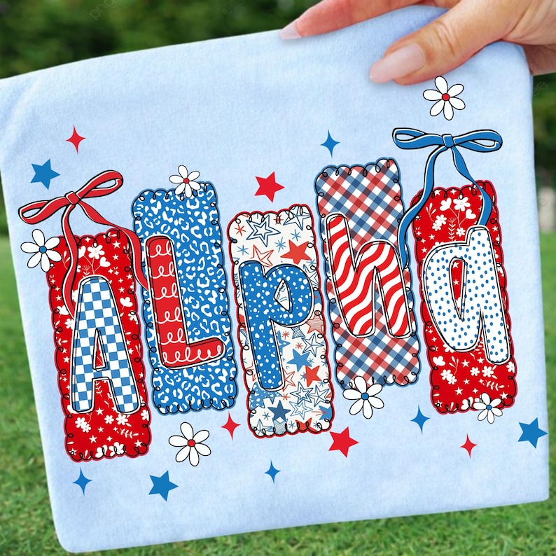 May include: A light blue fabric with the word "ALPHA" in red, white, and blue letters. Each letter has a unique pattern, including checkered, leopard print, stars, and wavy stripes. The letters are decorated with bows, flowers, and stars.