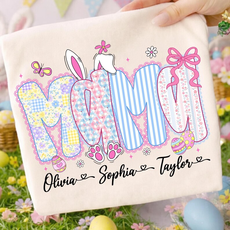 May include: Cream-colored Easter-themed pillowcase with the word "MAMI" in a colorful, patterned design. The letters feature floral, striped, and plaid patterns, with bunny ears and a bow. The names Olivia, Sophia, and Taylor are written below.