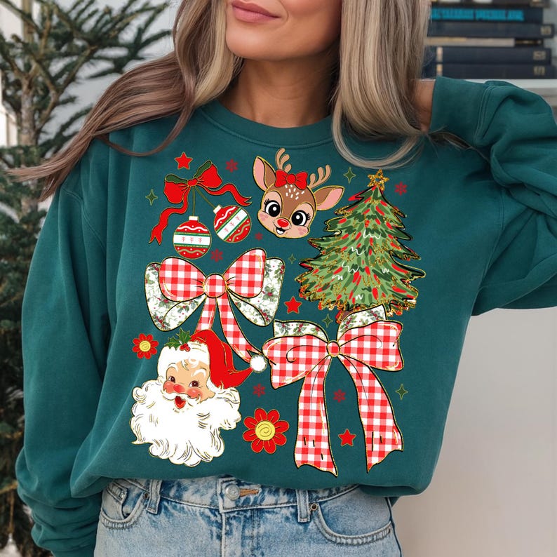 May include: Teal green sweatshirt featuring a Christmas-themed design. The design includes a reindeer with a red bow, Santa Claus, Christmas tree, ornaments, and red and white gingham bows. A festive holiday sweater.