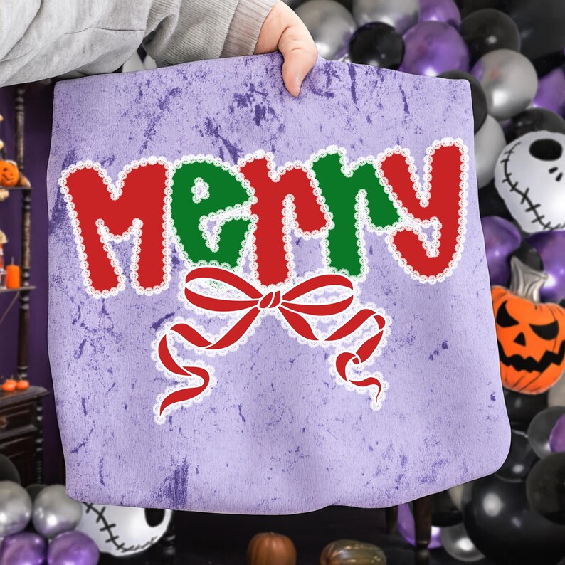 May include: A light purple tote bag with the word "MERRY" in red and green, outlined in white. A red bow with white trim is below the word. The bag has a distressed look.