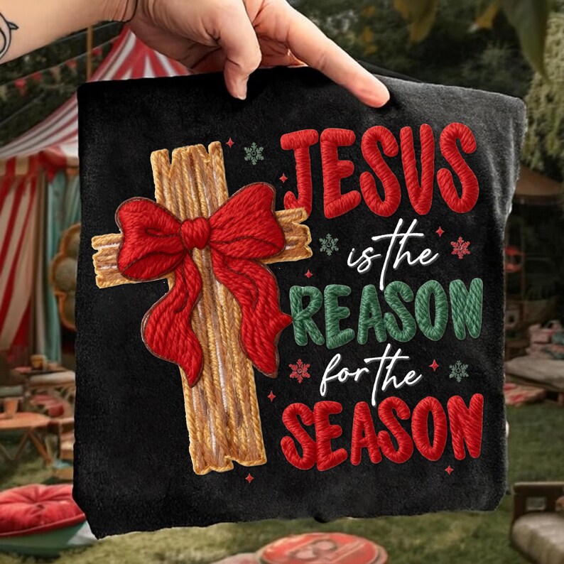 May include: Black square Christmas-themed pillow with the text "JESUS is the REASON for the SEASON." The pillow features a wooden cross with a red bow and snowflakes.