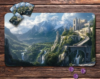 May include: A rectangular gaming mouse pad featuring a fantasy landscape with a castle, waterfalls, and mountains. Several matching cards and three purple dice are also visible on a wooden surface.