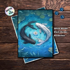 May include: Art print featuring two koi fish, one black and one white, swimming in a pond with lily pads and a lotus flower. The print has a white border and the text "White Border, Black Border, Borderless". A holographic sticker is in the upper left corner.