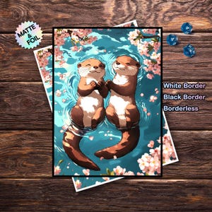 May include: A print depicting two cartoon otters holding hands in a blue water scene with pink cherry blossoms. The otters have brown fur and white bellies. The print has a black border and the words "White Border", "Black Border", and "Borderless" are visible.