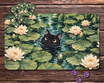 May include: A rectangular playmat featuring a black cat head emerging from a pond filled with green lily pads and white lotus flowers. A small stack of matching cards is positioned in the top left corner, and three purple polyhedral dice are nearby.