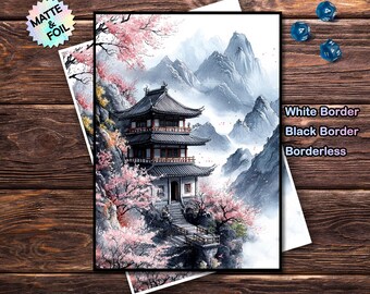 May include: A print featuring a Japanese pagoda nestled among mountains and cherry blossoms. The artwork has a black border and the text "White Border, Black Border, Borderless". The print is on a wooden surface.