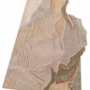 May include: A rectangular area rug featuring an abstract, topographical landscape design in shades of beige, tan, sage green, and terracotta. The surface displays a mix of smooth textures and raised, carved linear patterns resembling fields.
