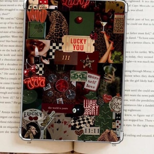 May include: A collage-style phone case featuring a mix of images and text. The design includes leopard print, playing cards, dice, cherries, and the words "Lucky You," "More Self Love," and "11:11." The color palette is dominated by red, green, and black.