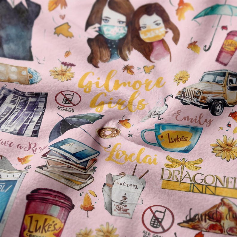 May include: Pink blanket with watercolor illustrations of the Gilmore Girls theme. Features the text "Gilmore Girls", "Luke's", "Dragonfly Inn", and other show-related imagery like a Jeep, coffee cups, and books.