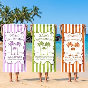 May include: Three beach towels with personalized text and palm tree designs. One is purple and white striped with "Olivia's Girls' Trip Bash" and "Maui, Hawaii". The second is green and white striped with "Liam's Beach Bum Club" and "Cabo San Lucas, Mexico". The third is orange and white striped with "Emma's Malibu Bachelorette" and "Malibu, California".