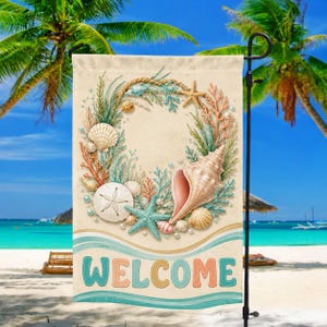 May include: A rectangular garden flag featuring a central wreath of seashells, starfish, coral, and pearls on a beige background. Below the wreath, the word WELCOME is printed in large, colorful block letters above wavy blue and green lines.