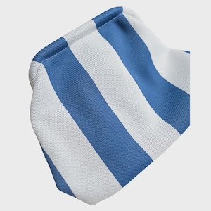 May include: A small pouch featuring a repeating vertical stripe pattern in alternating shades of bright blue and crisp white. The fabric has a visible, fine-textured weave, and the pouch is constructed with a rounded, soft-sided frame design.