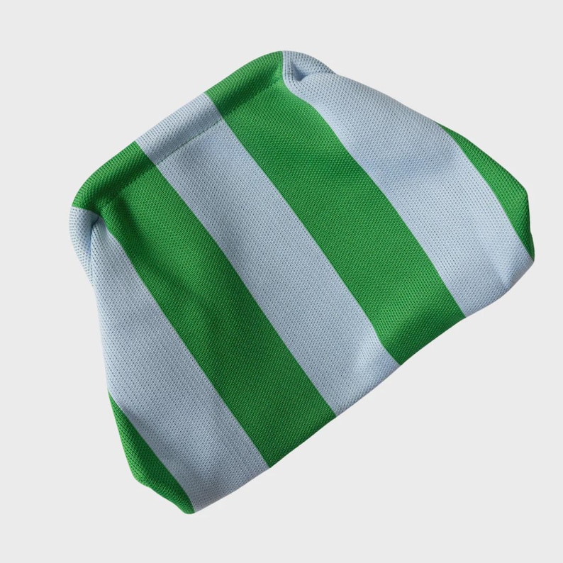 May include: A beanie hat featuring a repeating vertical striped pattern in bright green and light blue. The fabric has a visible textured knit construction, and the hat is shaped with a rounded top and a folded hem along the bottom edge.