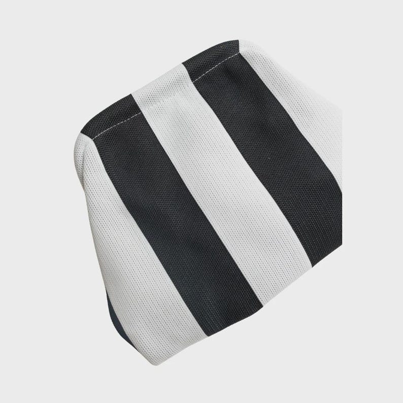 May include: A pouch featuring a bold, repeating pattern of thick vertical black and white stripes. The fabric has a visible, fine-textured weave throughout the entire surface, and the pouch is constructed with clean, stitched seams along the top edge.