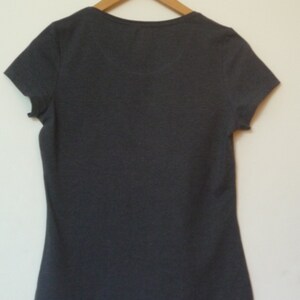 May include: A dark gray short-sleeved t-shirt with a v-neck.