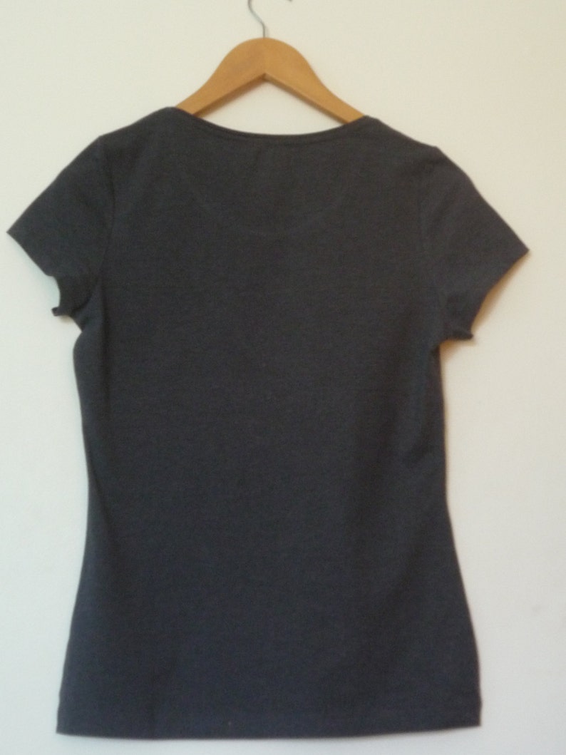May include: A dark gray short-sleeved t-shirt with a v-neck.