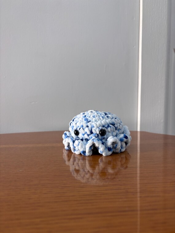 A hand-crocheted mini octopus amigurumi with muted, on-trend tones — the kind of desk companion that makes your workspace feel less corporate and more human.