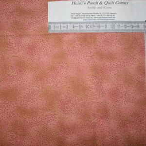 Könnte beinhalten: Nahaufnahme eines rosa Stoffes mit einem dezenten Muster aus kleinen goldenen Punkten. Im oberen rechten Eck des Bildes ist ein Lineal zu sehen. Das Lineal ist in Zentimetern und Zoll eingeteilt.