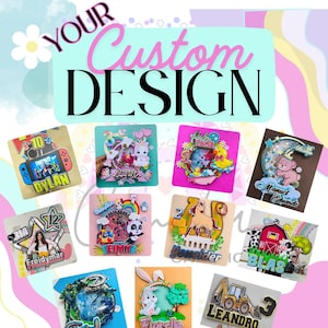 May include: A selection of custom cake toppers with diverse themes and names. The toppers include designs such as a video game console, unicorns, a panda, a horse, a baby, a farm scene, and a construction vehicle. The text "YOUR Custom DESIGN" is at the top.
