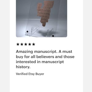 May include: A fragment of an ancient manuscript, displayed in a clear acrylic stand. The text is in a faded brown color, and the stand is supported by a clear base. The image includes the text: "Amazing manuscript. A must buy for all believers and those interested in manuscript history."