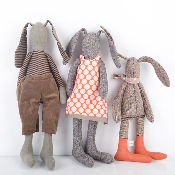 Easter bunny - mother father and child , he in Striped shirt and brown corduroy She in pink  dot dress the  boy with scarf and orange socks