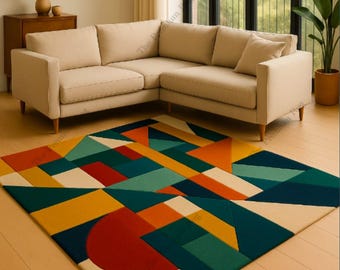 May include: A colorful geometric rug with a modern design. The rug features a pattern of various shapes in shades of red, orange, yellow, green, and blue. The rug is placed on a wooden floor in front of a beige sectional sofa.
