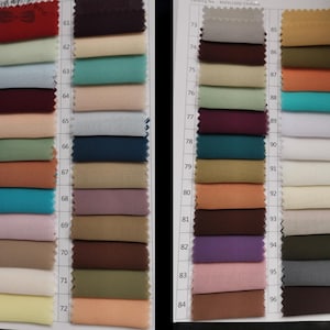 May include: A color swatch chart featuring a variety of fabric samples in shades of red, blue, green, and neutral tones. The chart includes a catalog number and a range of colors, ideal for fabric selection and design inspiration.