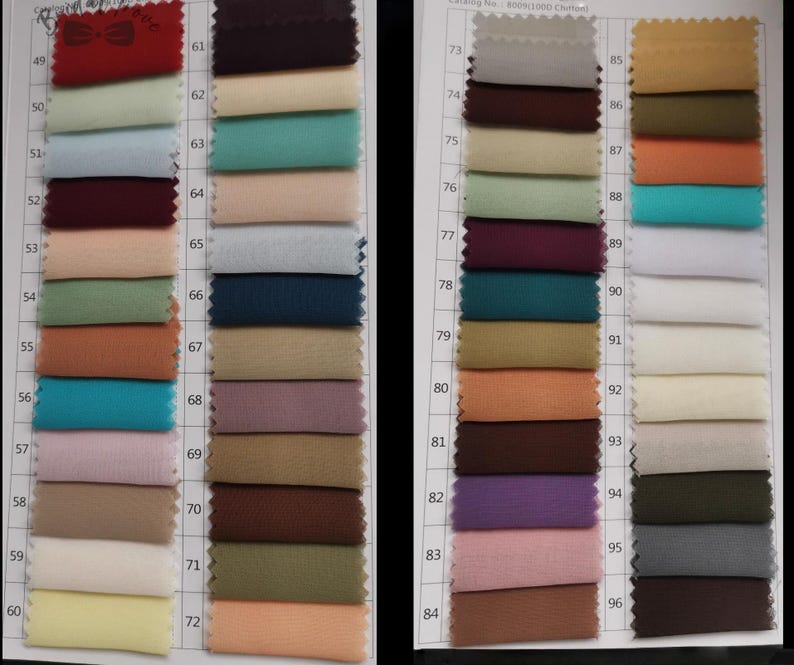 May include: A color swatch chart featuring a variety of fabric samples in shades of red, blue, green, and neutral tones. The chart includes a catalog number and a range of colors, ideal for fabric selection and design inspiration.