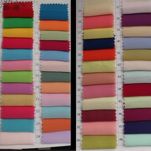 May include: A color swatch chart featuring 48 fabric samples in a variety of colors. The samples are arranged in rows and columns, with each sample labeled with a number. Colors include red, green, blue, orange, pink, purple, and yellow.