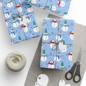 Frosty Friends Wrapping Paper: Cute Happy Snowmen Wearing Hats and Scarves on Blue Background with Snowflakes