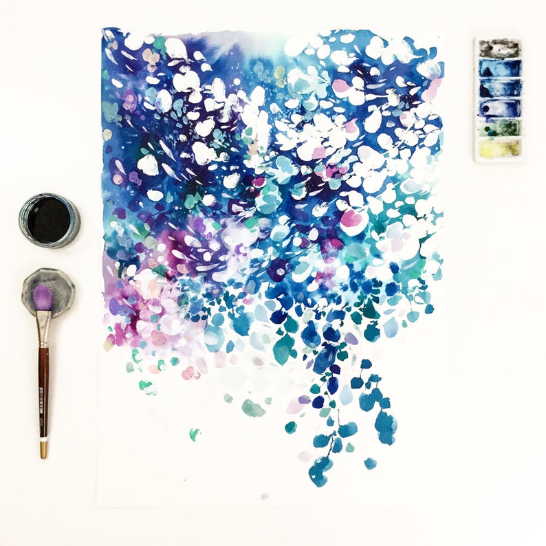May include: Watercolor painting with a vibrant display of blues, purples, and white. The artwork features a cascade of abstract shapes and forms, with a palette of turquoise, indigo, and violet. A paintbrush, ink, and a watercolor palette are also visible.
