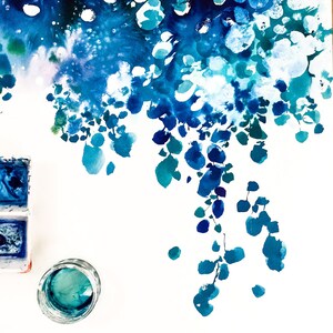 May include: Watercolor painting with a vibrant display of blues and teals. The artwork features abstract shapes and forms, with a focus on flowing, organic patterns. A small glass jar and watercolor palette are visible.