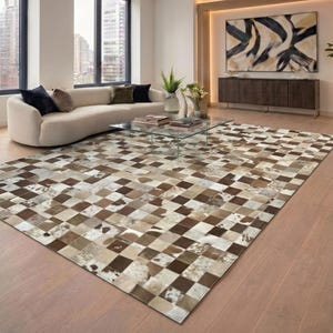 May include: A large, rectangular rug with a patchwork design. The rug has a checkerboard pattern in shades of brown, beige, and white. The rug is made of a natural material, possibly leather or hide, and adds a rustic touch to the room. The rug measures approximately 300cm x 200cm.