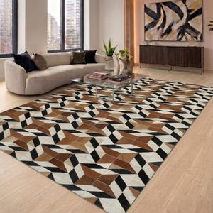 May include: A rectangular area rug featuring a geometric pattern composed of stitched panels in shades of brown, black, and white. The design consists of repeating star-like shapes and diamond motifs arranged in a grid across the entire surface.