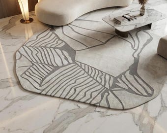 Alfombra abstracta tejida a mano: diseño orgánico en gris y marfil