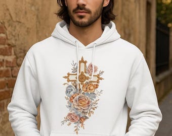 Könnte beinhalten: Weißer Kapuzenpullover mit einem goldfarbenen Kreuzdesign, das mit Blumen im Aquarellstil in Rosa-, Pfirsich- und Blautönen verziert ist. Der Hoodie hat eine Kapuze mit Kordelzug und eine Vordertasche. Das Design ist mittig auf der Vorderseite.