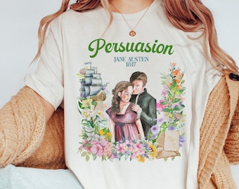 May include: A white t-shirt with a floral design and a couple in the center. The text "Persuasion" is at the top of the design, with "Jane Austen 1817" below it.