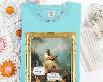 May include: A turquoise Comfort Colors t-shirt with a gold framed image of a man playing an instrument. The image has text that reads "brb. I can't remember if I remembered" and "to unplug my curling iron or lock the front door." A butterfly necklace is on the shirt.