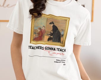May include: White t-shirt with a framed painting of a classroom scene. The text "TEACHERS GONNA TEACH" is printed on the shirt with an arrow pointing to the text "are going to" printed below. The text "MAGNUS ENCKELL ELEMENTARY SCHOOL 1899" is printed below the arrow.