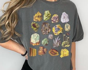 May include: A dark gray t-shirt with a graphic print of various colorful rocks and minerals.