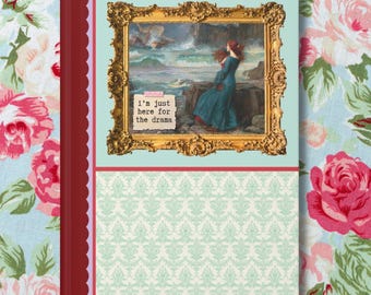 May include: A teal blue journal with a red and white border. The front cover features a gold framed painting of a woman standing on a rocky shore with a stormy sea in the background. The text "I'm just here for the drama" is printed on a white sticker in the lower left corner of the painting.