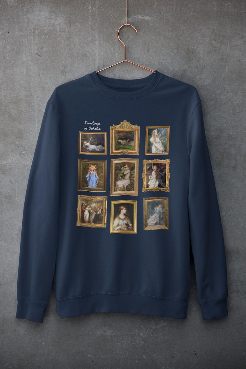 May include: Navy blue sweatshirt with a print of nine framed paintings of Ophelia. The text "Paintings of Ophelia" is printed above the paintings.