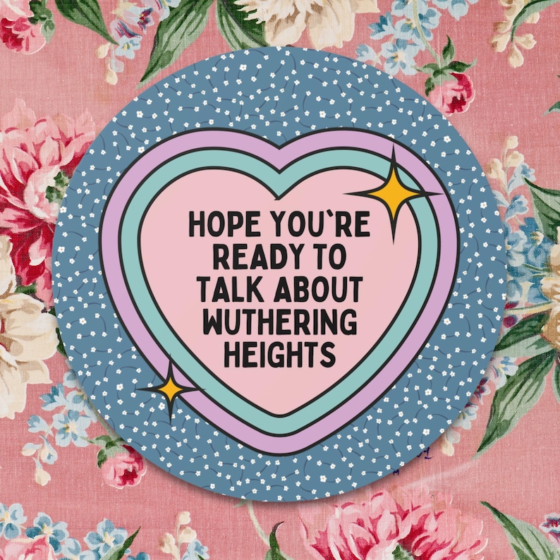 May include: A blue and pink heart-shaped sticker with the text "HOPE YOU'RE READY TO TALK ABOUT WUthering HEIGHTS" in white.