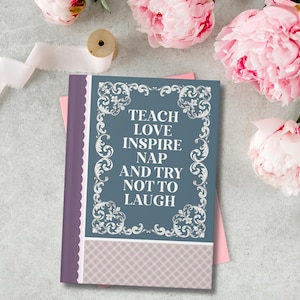 May include: A rectangular notebook with a blue cover featuring white ornate scrollwork borders and the text: TEACH LOVE INSPIRE NAP AND TRY NOT TO LAUGH. The spine is purple with a scalloped edge, and the bottom section has a light purple plaid pattern.