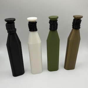 May include: Four bottle stoppers in black, white, olive green, and bronze. Each stopper has a cylindrical top and a black, ridged neck. The bottles have a simple, geometric design, suitable for wine or other beverages.