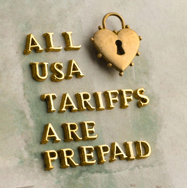 the text "ALL USA TARIFFS ARE PREPAID" in a stylized font, with a heart-shaped lock symbol above the text.