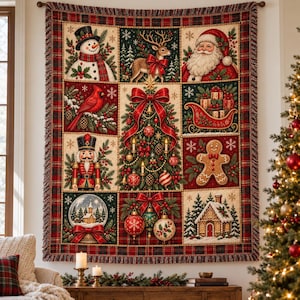 May include: A rectangular woven throw blanket featuring a grid of Christmas-themed illustrations including a snowman, reindeer, Santa Claus, cardinal, nutcracker, gingerbread man, snow globe, and a decorated tree with ornaments and red bows.