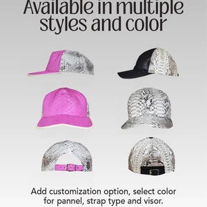 May include: A selection of baseball caps in different styles and colours. The caps have a snakeskin pattern and are shown with pink, black, and white visors. The text reads: "Available in multiple styles and colour."