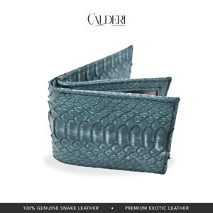 May include: A teal bi-fold wallet made of genuine snake leather. The wallet is open, revealing the interior. The brand name "CALDERI" is at the top. The bottom of the image reads "100% GENUINE SNAKE LEATHER" and "PREMIUM EXOTIC LEATHER."